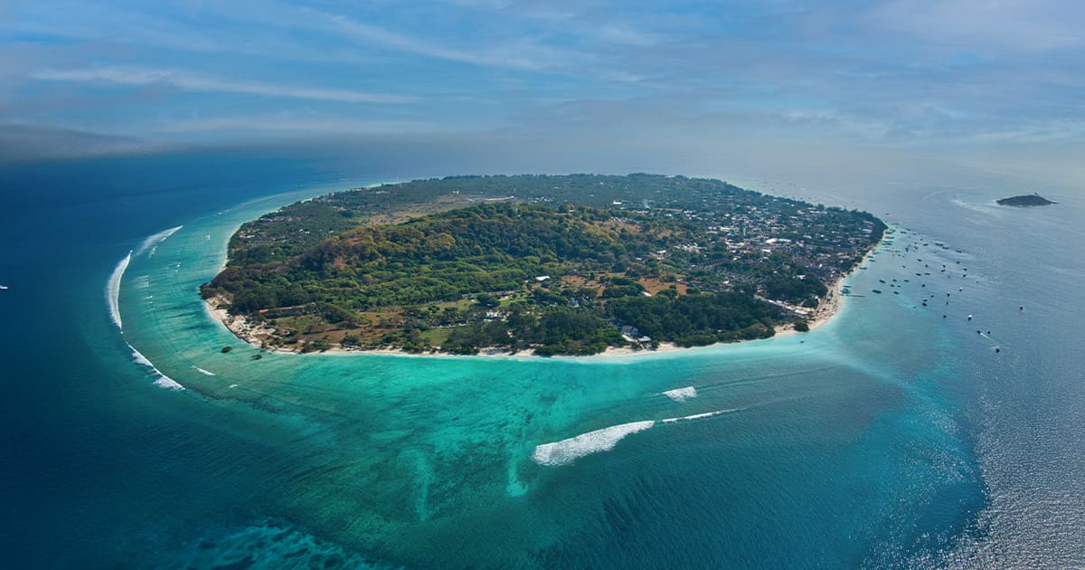 Aerial view of Gili Trawangan ringed by reef and pale blue water